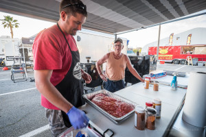 Justin McGlaun (left), from Waverly, Iowa, prepares a pan of meat while Mike Knox (right), from Grand Junction, Colorado, looks on. 