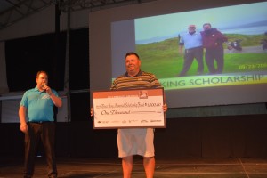 L-R Tournament Director, Christian Adderson presents a check for $1,000 to George Salcedo, founder of the Bruce King Memorial Scholarship Fund, Mesquite, Nevada, 2014 | Photo by Tyler Cooper of Mesquite Gaming, St. George News