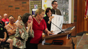 Debbie Justice (left, foreground) gets a surprise at the City Council meeting once she's told the sensory  garden at the All Abilities Park will be named after her, St. George, Utah, May 21, 2015 | Photo by Mori Kessler, St. George News