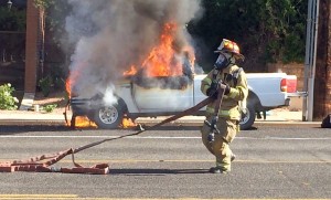 Firefighter battles a truck fire on Tabernacle Street, St. George, Utah, June 11, 2015 | Photo by Ric Wayman, St. George News