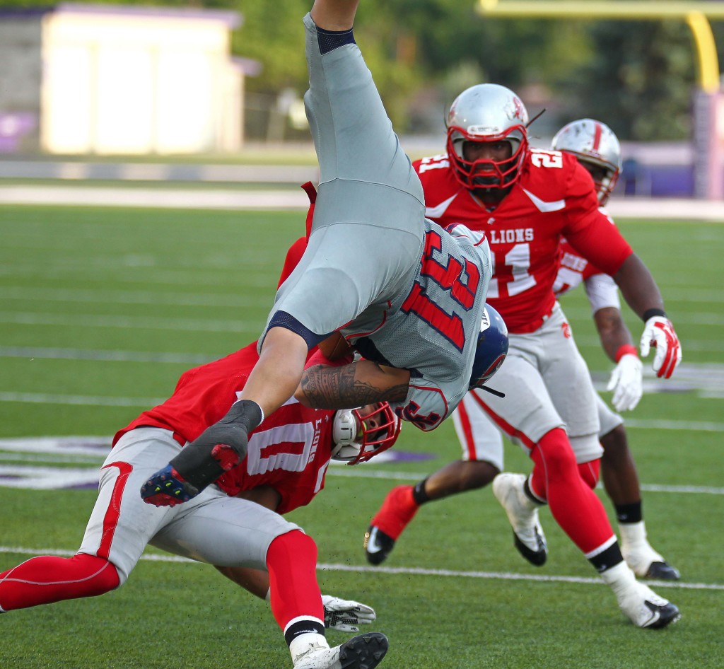 Lions defender Trey Smith (10) flips a Revolution ball carrier, Zion Lions vs. Wasatch Revolution, Ogden, Utah, June 27 2015, | Photo by Robert Hoppie, ASPpix.com, St. George News