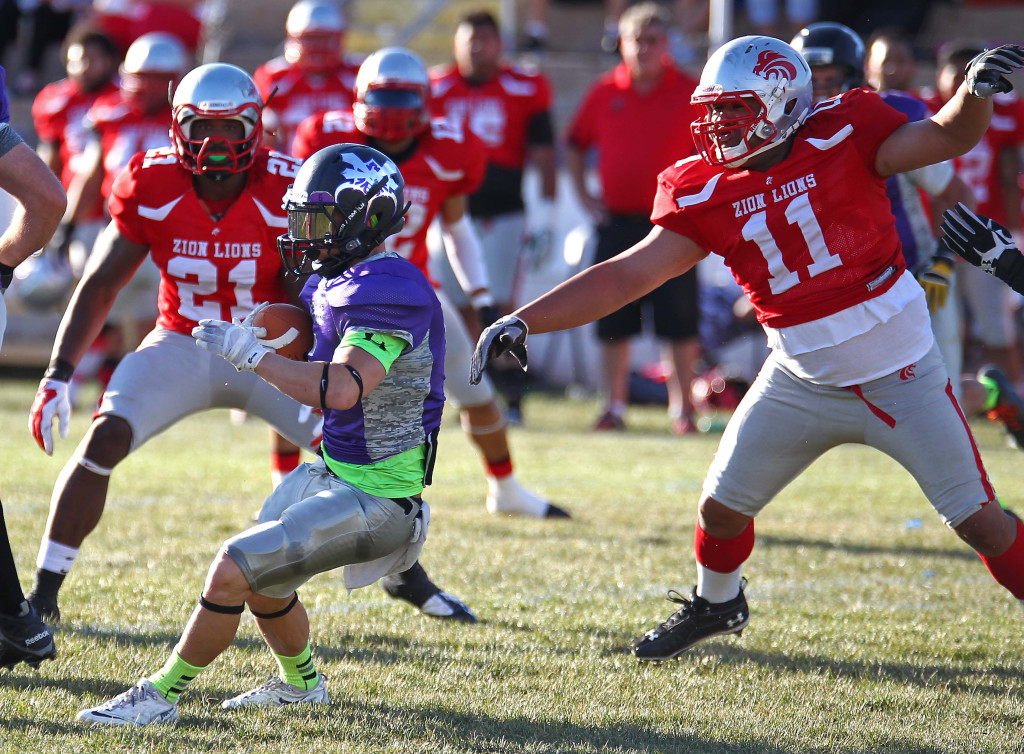 Lion defenders Doug Roberts (11) and Brandon Thompson (21) track down the Sting ball carrier, Zion Lions vs. Brigham Sting, Foorball, St. George, Utah, June 13, 2015, | Photo by Robert Hoppie, ASPpix.com, St. George News