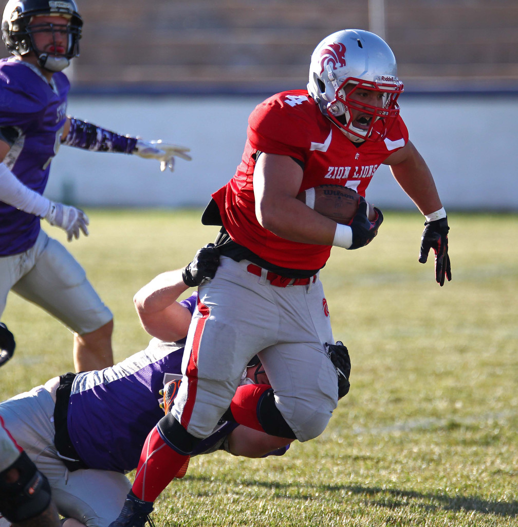 Lions running back Matt Feula (4) breaks a tackle, Zion Lions vs. Brigham Sting, Foorball, St. George, Utah, June 13, 2015, | Photo by Robert Hoppie, ASPpix.com, St. George News