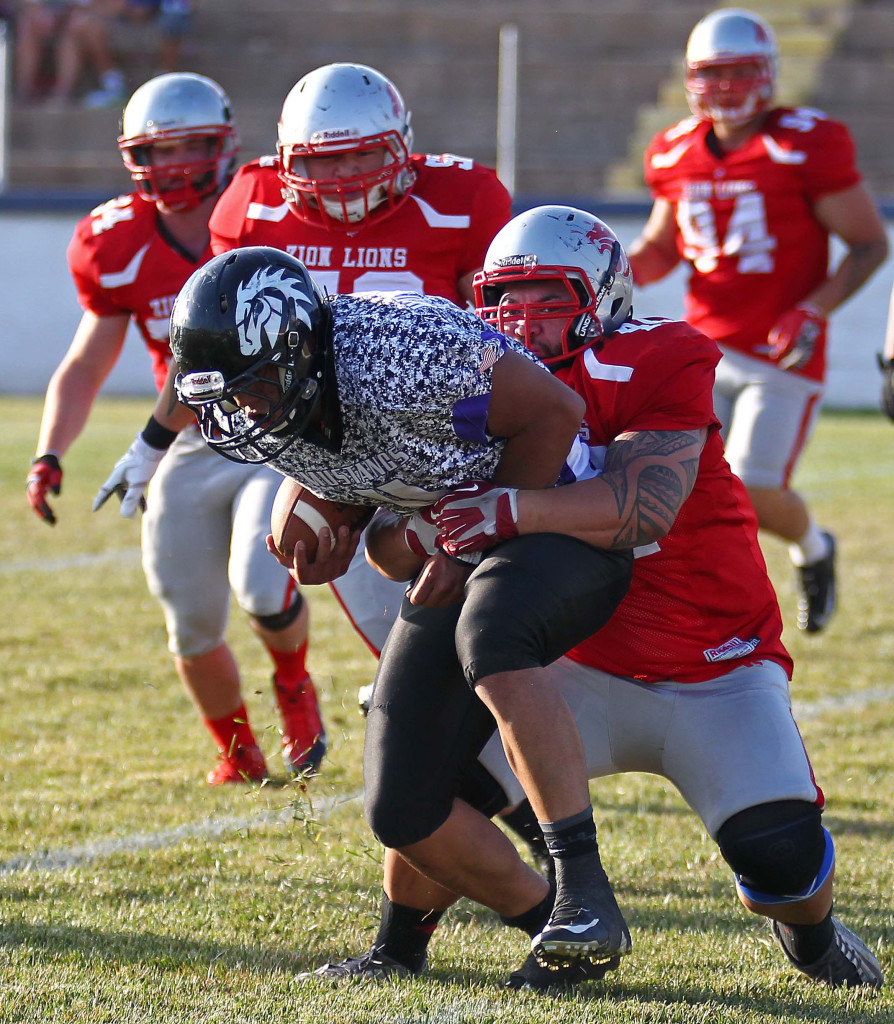 Joe Feula pulls down  Mustang quarterback in the backfield, Zion Lions vs. Idaho Mustangs, Football, St. George, Utah, June 20, 2015, | Photo by Robert Hoppie, ASPpix.com, St. George News