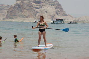 The author learning to stand-up paddleboard at Wahweap Beach, Page, Arizona, June 19, 2015 | Photo by Ralph Reina, St. George News