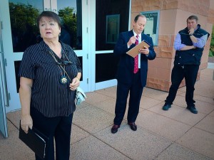 Washington County Constable Jean Dickson presides over an auction for Warren Jeffs' Cadillac Escalade on the steps of the 5th District courthouse, St. George, Utah, June 15, 2015 | Photo by Kimberly Scott, St. George News