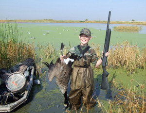 A young hunter shows the goose he took during a guided youth hunt, location unspecified, September 22, 2012 | Photo by Keith Fullencamp, St. George News