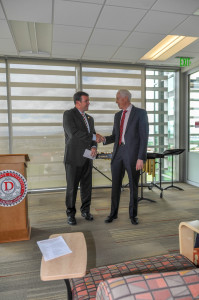 President Richard B. Williams accepts a $25,000 endowment check for the scholarship fund from Jordan Tanner, St. Geogre Utah, July 20, 2015 | Photo courtesy of Dixie State University, St. George News