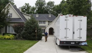 Federal authorities walk into the home of Subway restaurant spokesman Jared Fogle, Tuesday, July 7, 2015, in Zionsville, Ind. FBI agents and Indiana State Police have removed electronics from the property. FBI Special agent Wendy Osborne said Tuesday that the FBI was conducting an investigation in the Zionsville area but wouldn't confirm it involved Fogle, Zionville, Indiana, July 7, 3015 | AP Photo by Michael Conroy, St. George News