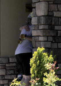 New Harmony volunteer firefighter stops to comfort homeowner Vickie Colvin who had a house fire Thursday that ravaged her home, 1006 S. Harmony Point Drive, New Harmony, Utah, July 09, 2015 | Photo by Carin Miller, St. George News