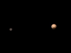 This image provided by NASA/Johns Hopkins University Applied Physics Laboratory/Southwest Research Institute shows Pluto, right, and its moon, Charon, from the New Horizons Long Range Reconnaissance Imager (LORRI) combined with lower-resolution color information from the spacecraft's Ralph instrument,  July 8, 2015 | PHoto by  NASA/JHUAPL/SWR, courtesy of Associated Press, St. George News