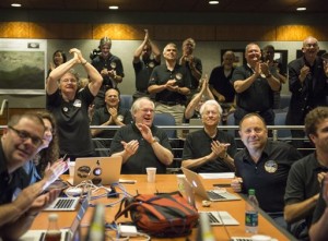 Members of the New Horizons science team react to seeing the spacecraft's last and sharpest image of Pluto before closest approach later in the day at the Johns Hopkins University Applied Physics Laboratory (APL) in Laurel, Maryland. NASA's New Horizons spacecraft was on track to zoom within 7,800 miles (12,500 kilometers) of Pluto,  Johns Hopkins University Applied Physics Laboratory,  Laurel, Maryland, Tuesday, July 14, 2015 | Photo by Bill Ingalls NASA via AP, St. George News 