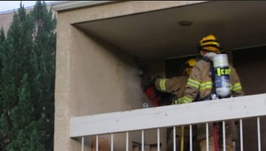 Firefighters cut into a wall at a house fire on Bloomington Drive, St. George, Utah, July 1, 2015 | Photo by Mori Kessler, St. George News