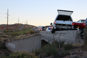 A truck hauling two Mazda Miatas was pushed onto a concrete barrier on a bridge after the trailer carrying the Miatas began to whip and the driver lost control of the truck and trailer, Leeds, Utah, July 28, 2015 | Photo by Nataly Burdick, St. George News