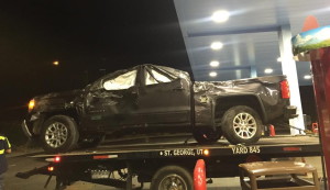 Damaged truck being taken away by a wrecker after being removed from the bottom of an embankment by the Virgin River where it rolled after leaving the roadway, St. George, Utah, July 18, 2015 | Photo courtesy of Marty Martak, St. George News