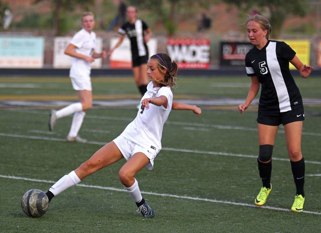 Hadley Cowan (4) reaches for a ball, Desert Hills vs. Syracuse, Girls Soccer, St. George, Utah, Aug. 19, 2015, | Photo by Robert Hoppie, ASPpix.com, St. George News