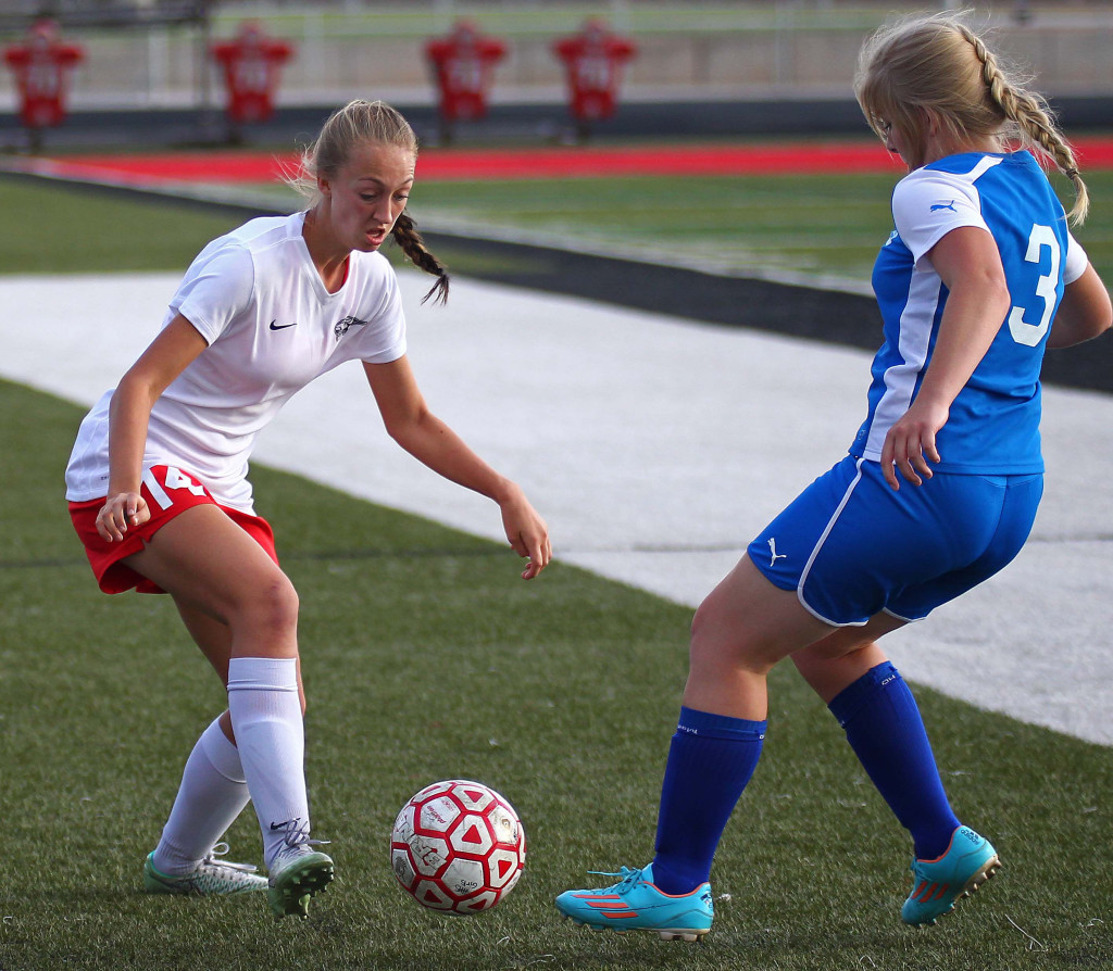 Kenzie Beardall (14) fights for a loose ball for the Tigers, Hurricane vs. Beaver, Girls Soccer, St. George, Utah, Aug. 27, 2015, | Photo by Robert Hoppie, ASPpix.com, St. George News