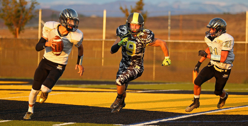 Diamond Ranch defensive back Corey Tullen (9) in pursuit of the Desert Hills quarterback Kobe SattiewhiteDiamond Ranch Academy vs. Desert Hills JV, Football, Hurricane, Utah, Aug. 27, 2015, | Photo by Robert Hoppie, ASPpix.com, St. George News