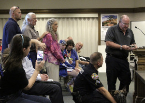 Cedar City Police Chief Bob Allinson awards Dennis and June Schnarr with a challenge coin,  Cedar City Council Chambers, Cedar City, Utah, August 12, 2015 | Photo by Carin Miller, St. George News