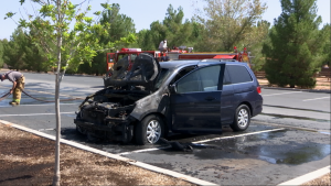 The smoldering remains of a Honda Odyssey sit in a parking lot after a mechanical issue resulted in a vehicle fire, Bloomington Park, St. George, Utah, Aug. 18, 2015 | Photo by Devan Chavez, St. George News