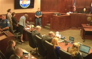 In this image made from Colorado Judicial Department video, Defense Attorney Tamara Brady, at left in stripped suit, leans into the defense table as Judge Carlos A. Samour, Jr., top right, reads the jury's sentencing verdict in the Colorado theater shooting trial in Centennial, Colo., Aug. 7, 2015 | Photo  courtesy of Colorado Judicial Department via AP, St. George News