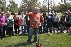 Tom Sullivan, whose son Alex was killed in the 2012 Aurora movie theatre attack, backed by the families of those killed and wounded, speaks with members of the media after Colorado movie theater shooter James Holmes was formally sentenced, outside Arapahoe County District Court Holmes who unleashed a murderous attack on a packed Colorado movie theater was ordered Wednesday to serve life in prison without parole plus 3,318 years — the maximum allowed by law — before the judge told deputies, "Get the defendant out of my courtroom, please." Centennial, Colo., Aug. 26, 2015 | AP Photo by Brennan Linsley, St. George News