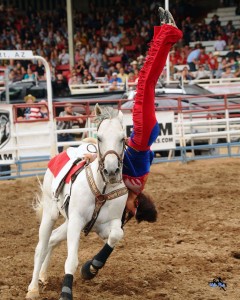 Trick rider performs a dive while riding on a horse, location and date unspecified | Photo courtesy of Cherry Creek Radio, St. George News