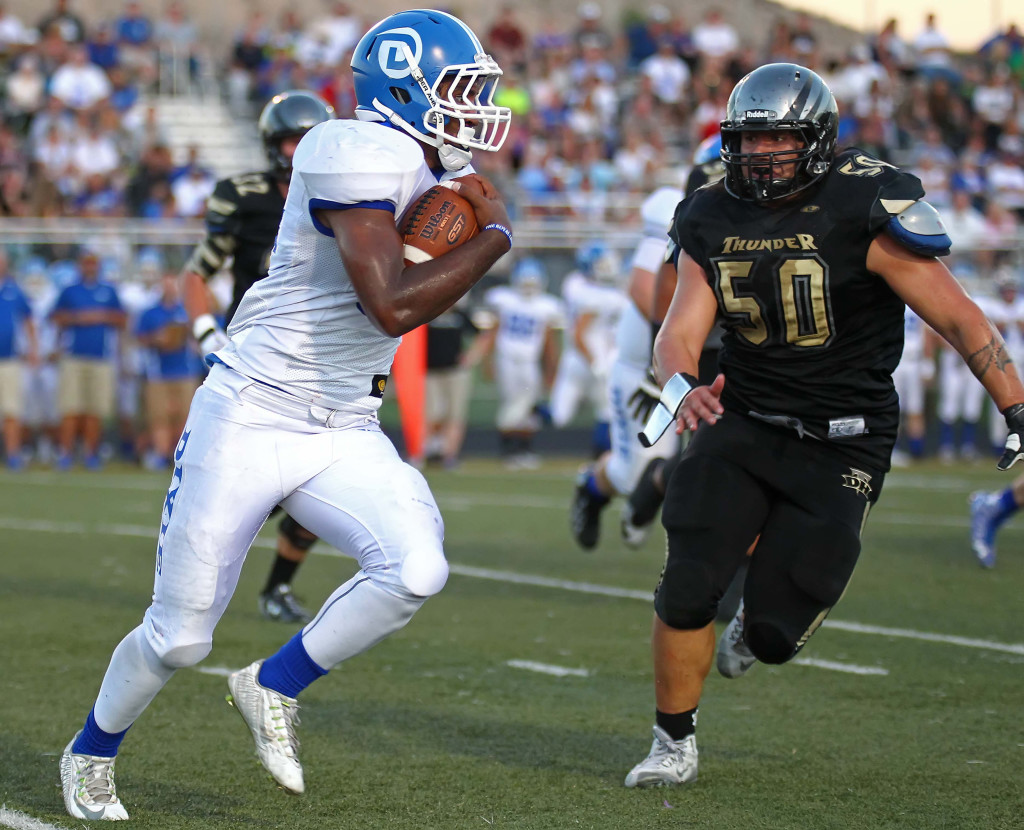 Dixie running back Tre Miller is tracked down by Desert Hills' Justice Alo (50), Desert Hills vs. Dixie, Football, St. George, Utah, Sept. 25, 2015, | Photo by Robert Hoppie, ASPpix.com, St. George News