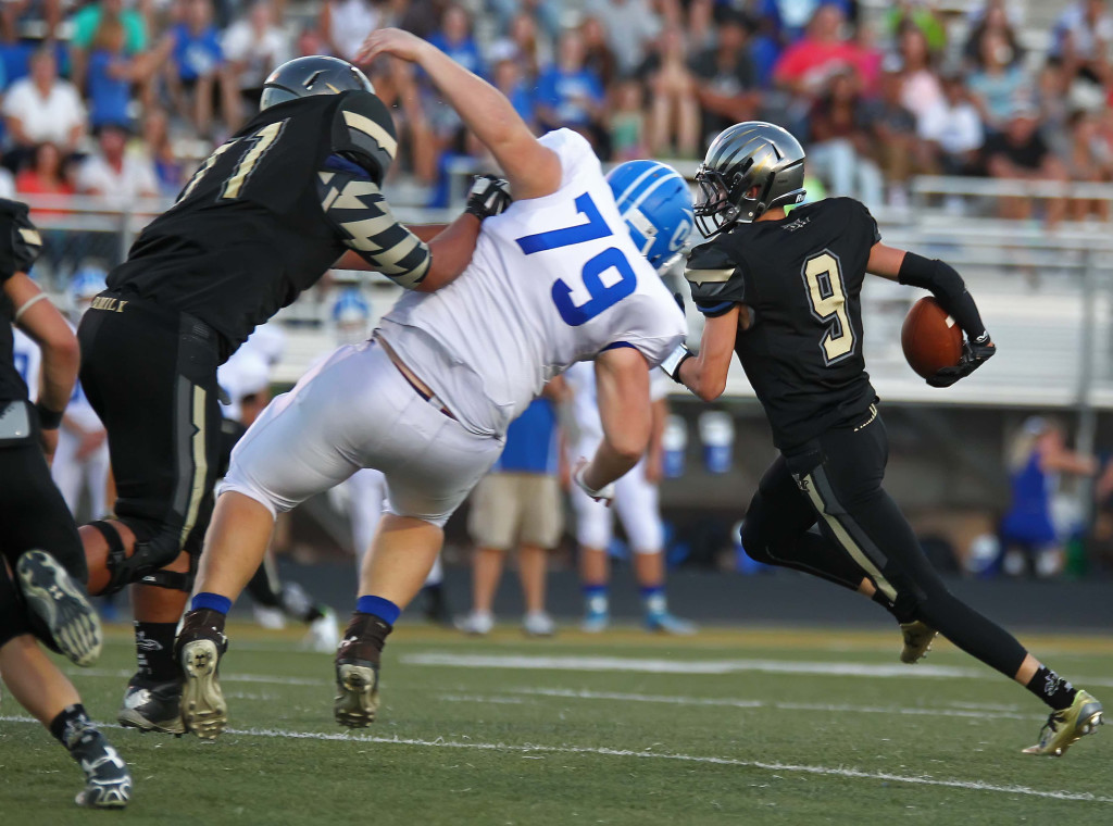 Thunder defensive back Kobe Sattiewhite (9) runs back an interception as Bundy Sewell (71) lays a big block, Desert Hills vs. Dixie, Football, St. George, Utah, Sept. 25, 2015, | Photo by Robert Hoppie, ASPpix.com, St. George News