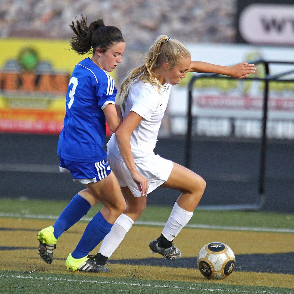 Lady Thunder striker Brook Lott controls the ball and heads for the goal with Dixie's Delaney Story (3) defending, Desert Hills vs. Dixie, Girls Soccer, St. George, Utah, Sept. 10, 2015, | Photo by Robert Hoppie, ASPpix.com, St. George News