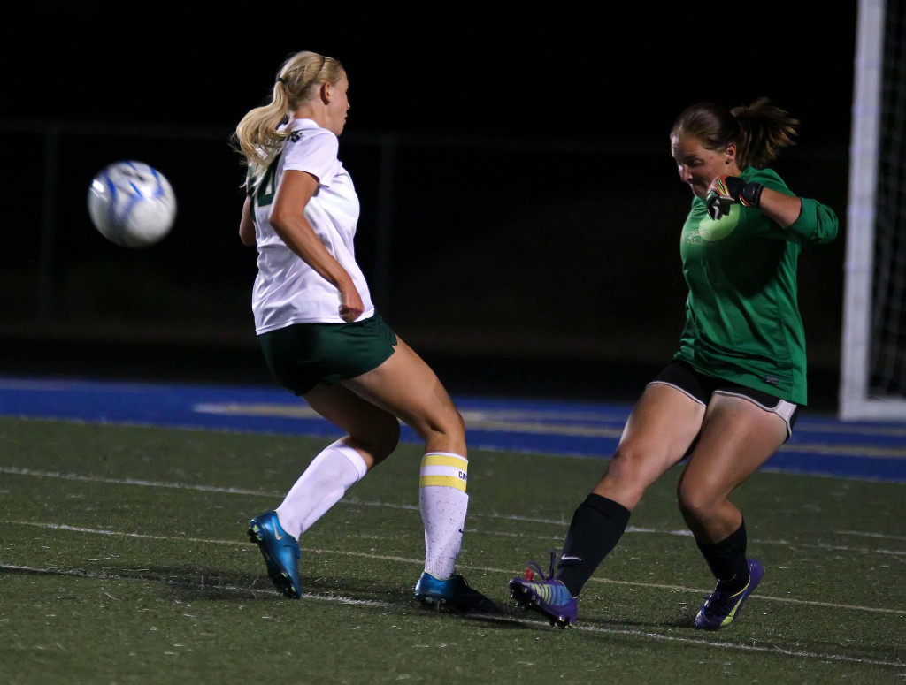 Snow Canyon's Jenny Stewart and Cedar goalkeeper Megan Giddings, Snow Canyon vs. Cedar, Girls Soccer, St. George, Utah, Sept. 29, 2015, | Photo by Robert Hoppie, ASPpix.com, St. George News