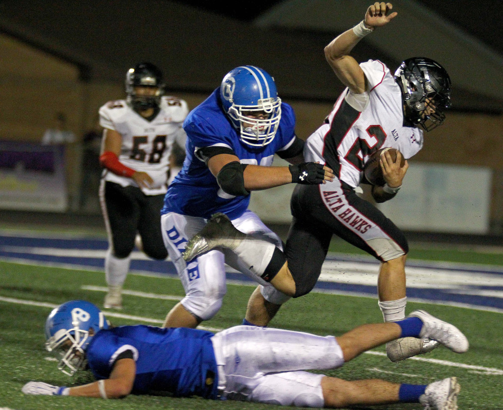 Jeff Martinez takes down an Alta ball carrier, Dixie vs. Alta, Football, St. George, Utah, Sept. 4, 2015, | Photo by Robert Hoppie, ASPpix.com, St. George News