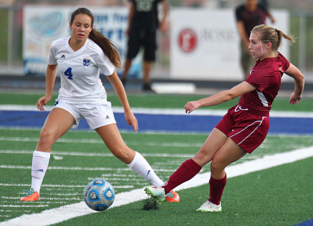 Cedar's Brooklyn Shakespeare and Dixie's McKenna McAllister (4) fight for a loose ball, Dixie vs. Cedar, Girls Soccer, St. George, Utah, Sept. 8, 2015, | Photo by Robert Hoppie, ASPpix.com, St. George News