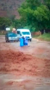 A photo taken just moments before the tragic flash flooding unfolded shows three women and their van and SUV, both occupied by their 13 children, as they waited near the widening stream for the water to recede so they could cross, Hildale, Utah, Sept. 14, 2015 | Photo courtesy of John Willis Barlow, St. George News