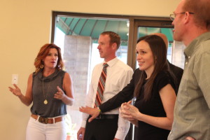 L-R: Travel Channel's "Hotel Impossible" designer Anne Rue, Stratford Court Hotel General Manager Enoch Seegmiller, owners Steve and Gina Nelson, and others look at renovations made during the show's production. Cedar City, Utah, March 2014 | Photo courtesy of Travel Channel, St. George News