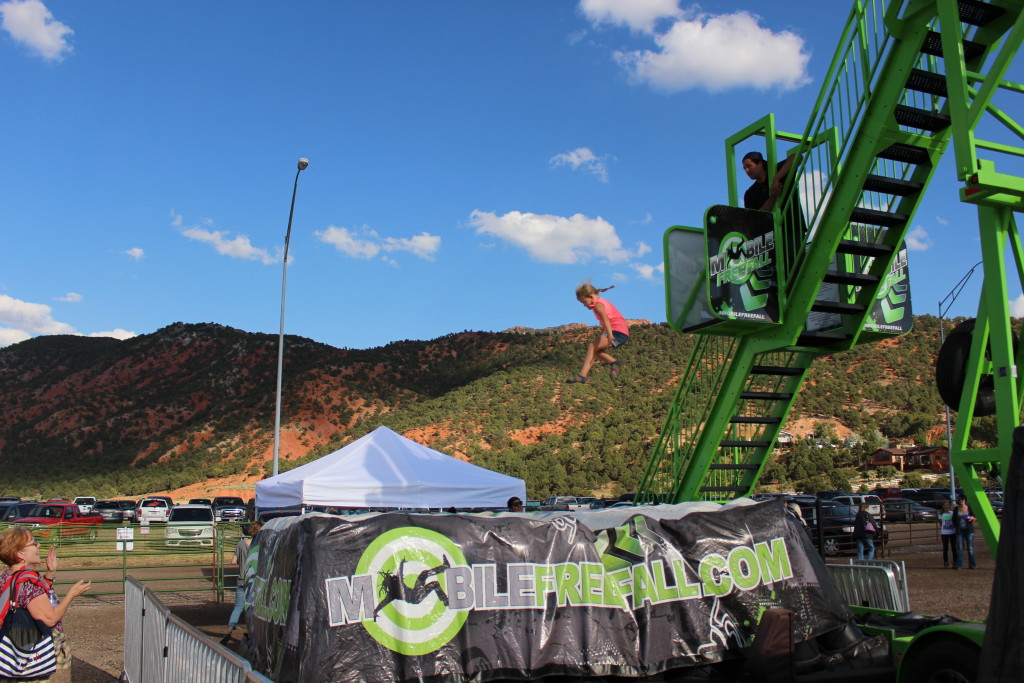 A fair-goer jumps off the short jump at the Mobile Free Fall at the Iron County Fairgrounds, Parowan, Utah, Sept. 5, 2015 | Photo by Emily Hammer, St. George News