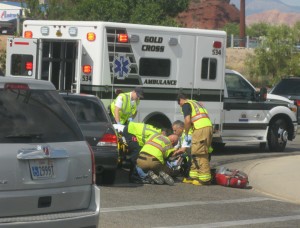 Paramedics and fire department personnel treat a man clipped by a car Saturday afternoon, St. George, Utah, Sept. 5, 2015 | Photo by Ric Wayman, St. George News