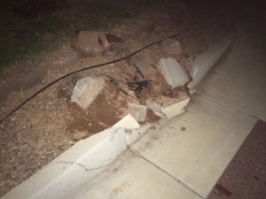 A city curb is heavily damaged in a two-vehicle accident, St. George, Utah, Sept. 29, 2015 | Photo by Mori Kessler, St. George News