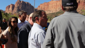 Utah Gov. Gary Herbert looking into a pit carved out by a flash flood that carried away two two vehicles full of women and children. The incident left 12 people dead and one missing, Hildale, Utah, Sept. 19, 2015 | Photo courtesy of the Office of the Governor St. George News