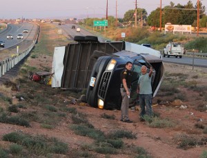 The driver of a Ford pickup and trailer that rolled in the median of I-15 tells Utah Highway Patrol trooper Grant Hintze what happened, Washington, Utah, September 11, 2015 | Photo by Ric Wayman, St. George News