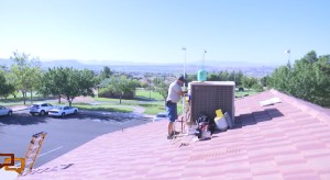 A Facility Service's technician services an air conditioning unit atop a city building to make sure those inside remains cool and comfortable, St. George, Utah, Sept. 3, 2015 | Photo by Sheldon Demke, St. George News 