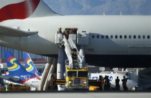 Firefighters enter a plane that caught fire at McCarran International Airport. An engine on the British Airways plane caught fire before takeoff, forcing passengers to escape on emergency slides, Las Vegas, Nevada, Sept. 8, 2015 | AP Photo/John Locher, St. George News