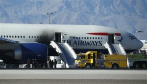 Firefighters enter a plane that caught fire at McCarran International Airport. An engine on the British Airways plane caught fire before takeoff, forcing passengers to escape on emergency slides, Las Vegas, Nevada, Sept. 8, 2015 | AP Photo/John Locher, St. George News