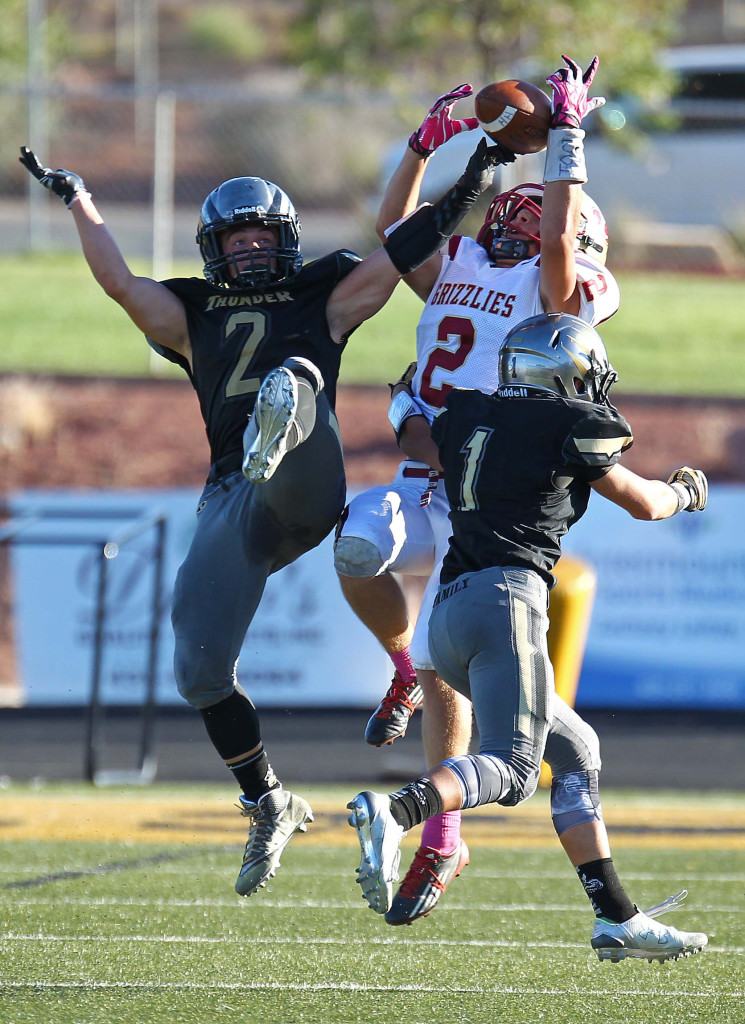 Stetson Wood (2) and Cody Ricketts (1) break up a pass intended for Logan's Spencer Corbett, Desert Hills vs. Logan, Football, St. George, Utah, Oct. 14, 2015, | Photo by Robert Hoppie, ASPpix.com, St. George News