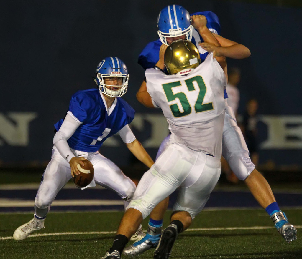 Dixie's Zac Harrah (1) is harassed by Snow Canyon's Joe Servati (52), Dixie vs. Snow Canyon, Football, St. George, Utah, Oct. 1, 2015, | Photo by Robert Hoppie, ASPpix.com, St. George News