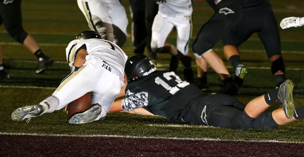 Desert Hills' Cody Ricketts (1) and Pine View quarterback Riley Livingston (13) collide while chasing a loose ball, Pine View vs. Desert Hills, Football, St. George, Utah, Oct. 2, 2015, | Photo by Robert Hoppie, ASPpix.com, St. George News