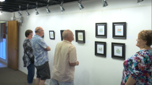 Exhibit visitors take a moment to ponder some of Gubler's paintings at the DiFiore Center, St. George, Utah, Oct. 2, 2015 | Photo by Sheldon Demke, St. George News