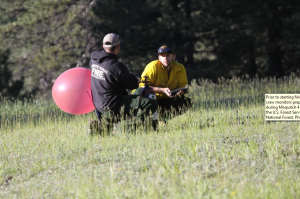 Prior to starting firing operations, North Zone fire effects crew monitors prepare a balloon for a PIBAL operation during Moquitch 4 prescribed fire, June 22, 2015, Southwestern Region, Kaibab National Forest | Photo courtesy of the U.S. Forest Service, David Hercher, St. George News