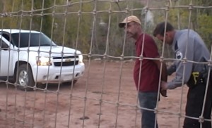 A member of the Hildale-Colorado City Marshal's Office places Andrew Chatwin under arrest, Colorado City, Arizona, Oct. 13, 2015 | Video screenshot image, courtesy of Isaac Wyler, St. George News