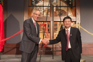 SUU President Scott Wyatt and Hunan Normal University President Jiang Hongxin shake hands after tying a ribbon together, symbolizing the bringing together of two cultures, as part of the Confucius Institute opening celebration, Cedar City, Utah, Sept. 28, 2015 | Photo courtesy of Southern Utah University, St. George News